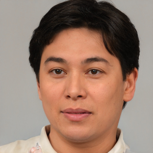 Joyful asian young-adult male with short  brown hair and brown eyes