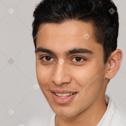 Joyful white young-adult male with short  brown hair and brown eyes