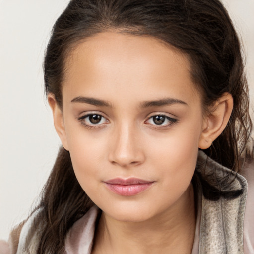 Joyful white child female with long  brown hair and brown eyes