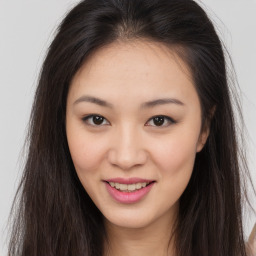 Joyful asian young-adult female with long  brown hair and brown eyes