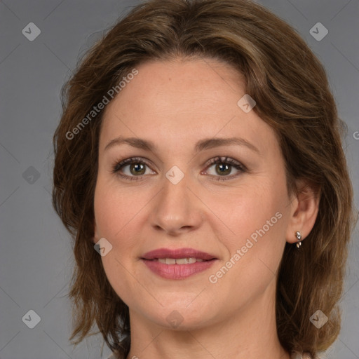 Joyful white adult female with medium  brown hair and grey eyes