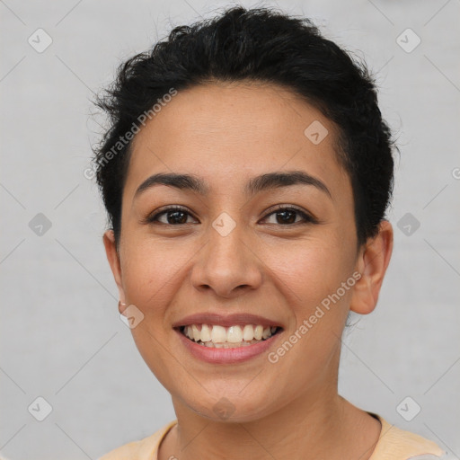 Joyful latino young-adult female with short  brown hair and brown eyes