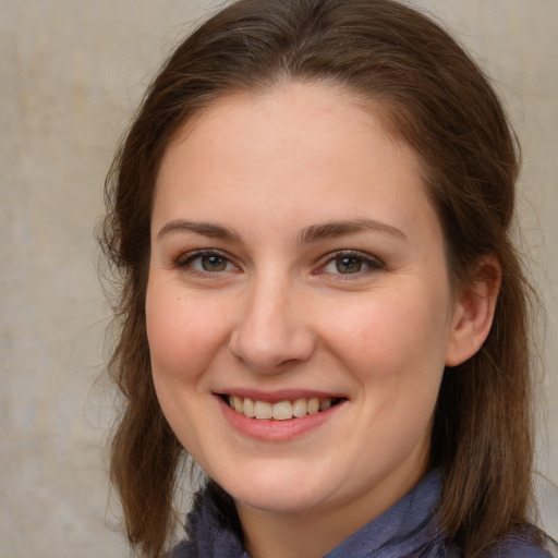 Joyful white young-adult female with long  brown hair and grey eyes