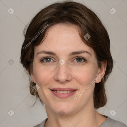 Joyful white adult female with medium  brown hair and grey eyes