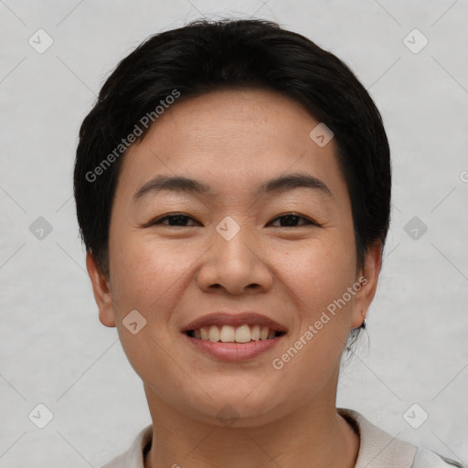 Joyful asian young-adult female with short  black hair and brown eyes