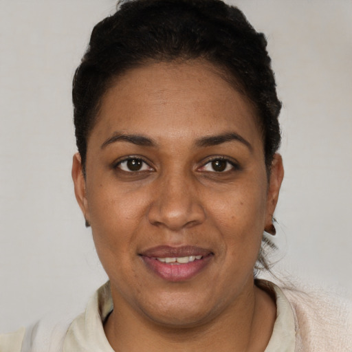 Joyful black adult female with short  brown hair and brown eyes