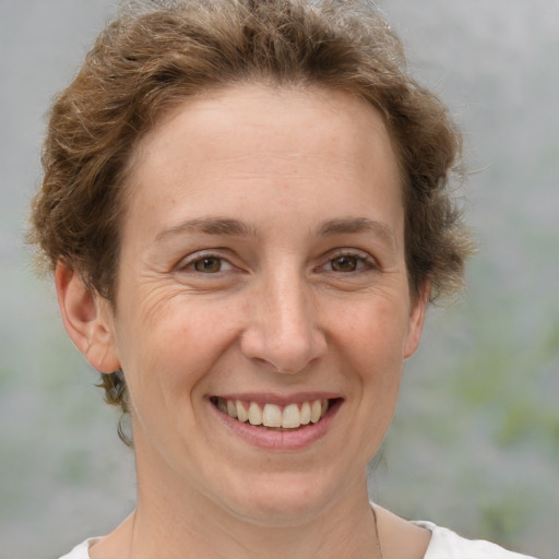 Joyful white adult female with short  brown hair and brown eyes