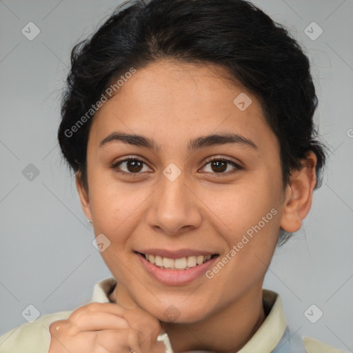 Joyful latino young-adult female with short  brown hair and brown eyes