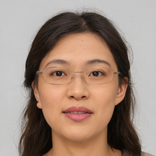 Joyful white adult female with long  brown hair and brown eyes