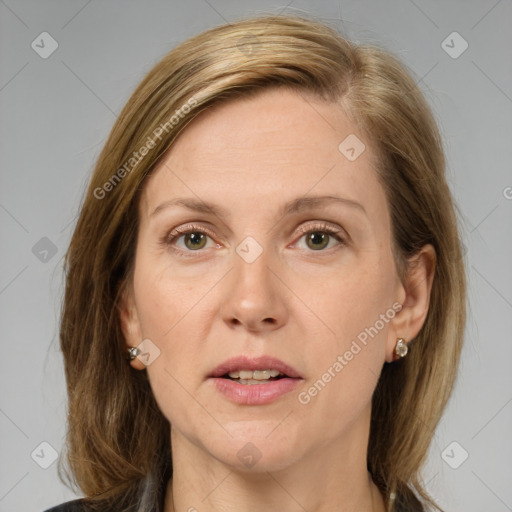 Joyful white adult female with medium  brown hair and grey eyes