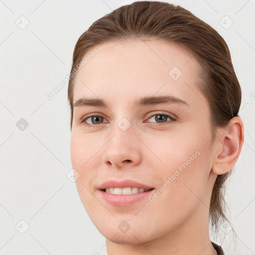 Joyful white young-adult female with long  brown hair and grey eyes