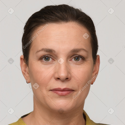 Joyful white adult female with short  brown hair and grey eyes