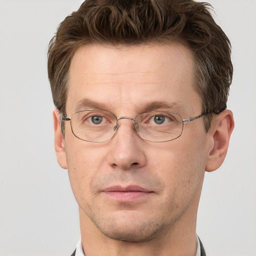 Joyful white adult male with short  brown hair and grey eyes