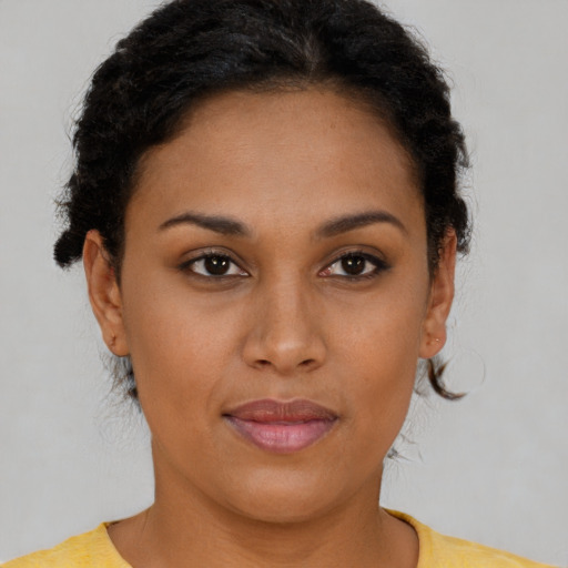 Joyful latino young-adult female with short  brown hair and brown eyes