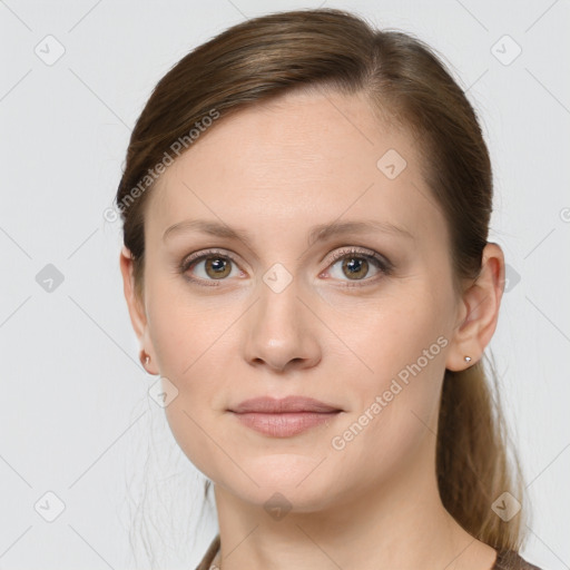 Joyful white young-adult female with long  brown hair and grey eyes