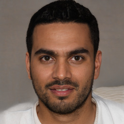 Joyful latino young-adult male with short  black hair and brown eyes