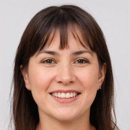 Joyful white adult female with long  brown hair and brown eyes