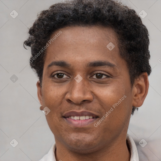 Joyful black young-adult male with short  brown hair and brown eyes