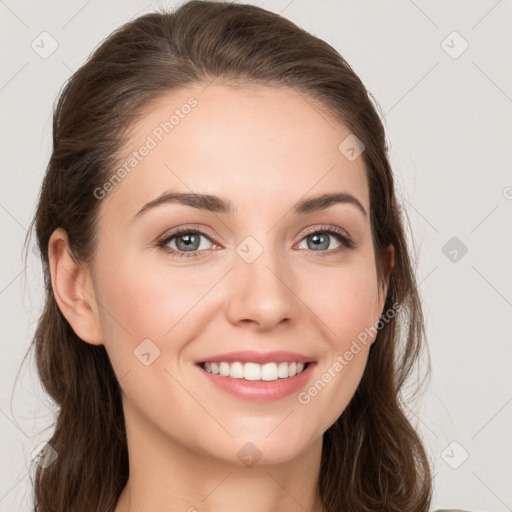 Joyful white young-adult female with long  brown hair and grey eyes