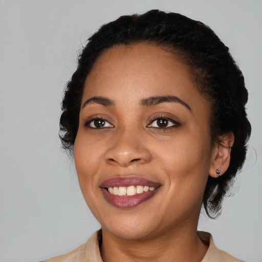 Joyful black young-adult female with medium  black hair and brown eyes