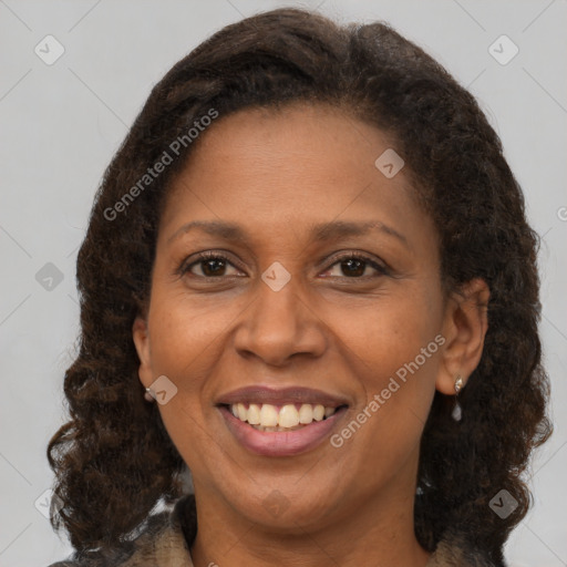 Joyful black adult female with medium  brown hair and brown eyes