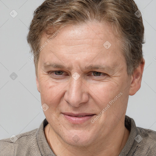 Joyful white middle-aged male with short  brown hair and grey eyes