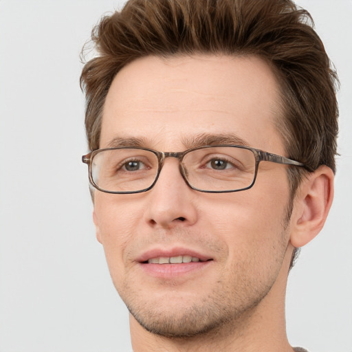 Joyful white adult male with short  brown hair and grey eyes