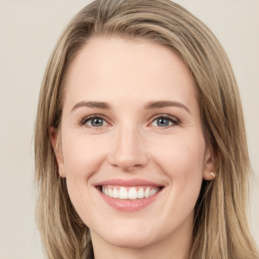 Joyful white young-adult female with long  brown hair and green eyes