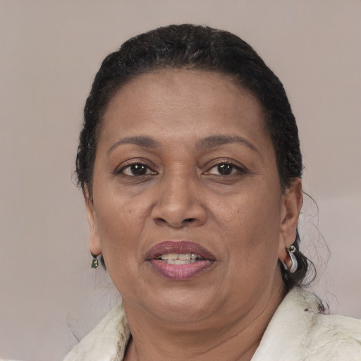 Joyful black adult female with short  brown hair and brown eyes