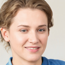 Joyful white young-adult female with medium  brown hair and blue eyes