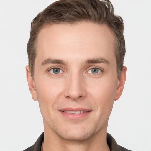 Joyful white young-adult male with short  brown hair and grey eyes