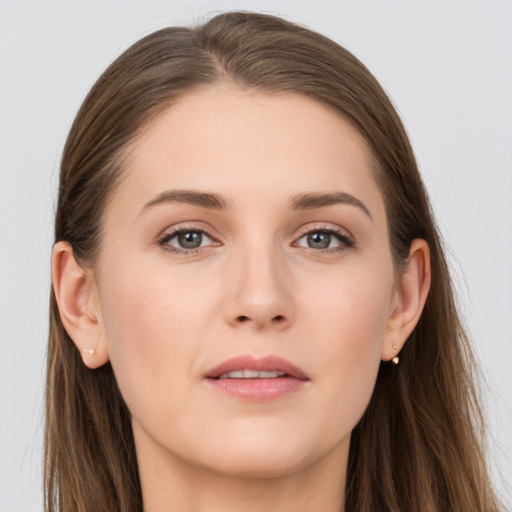 Joyful white young-adult female with long  brown hair and grey eyes