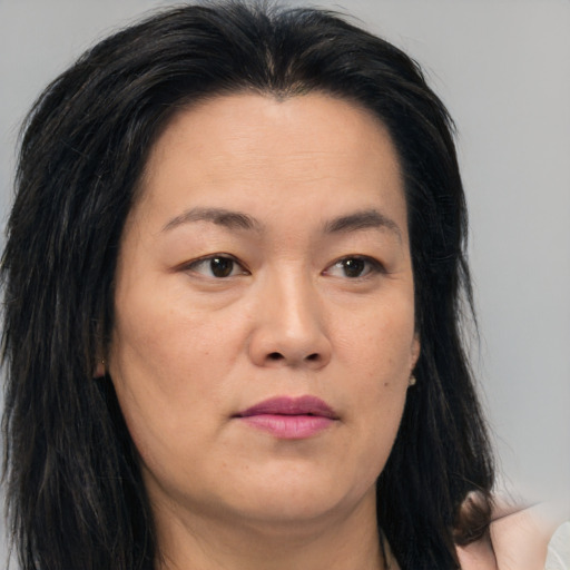 Joyful asian young-adult female with long  brown hair and brown eyes