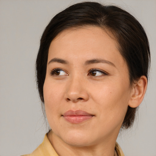Joyful asian young-adult female with medium  brown hair and brown eyes