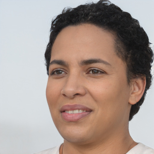 Joyful latino young-adult female with short  black hair and brown eyes