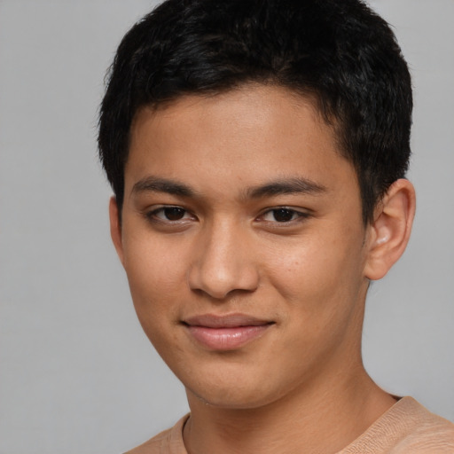 Joyful latino young-adult male with short  brown hair and brown eyes