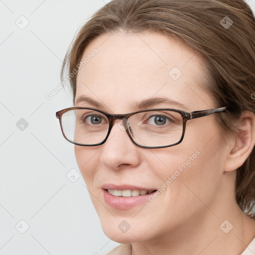 Joyful white young-adult female with medium  brown hair and grey eyes