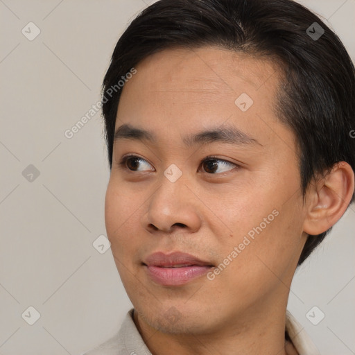 Joyful asian young-adult male with short  brown hair and brown eyes