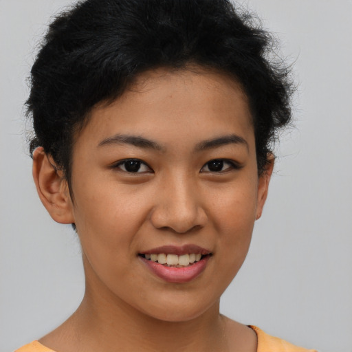 Joyful latino young-adult female with short  brown hair and brown eyes