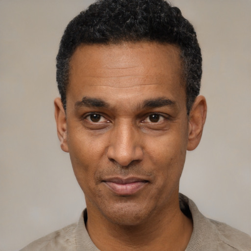 Joyful latino adult male with short  black hair and brown eyes