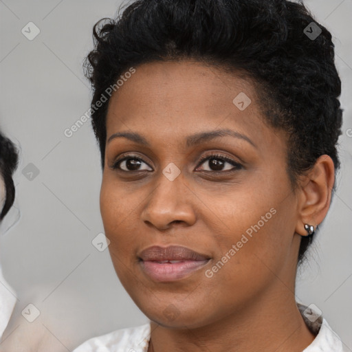 Joyful black young-adult female with short  black hair and brown eyes