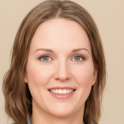 Joyful white young-adult female with medium  brown hair and green eyes