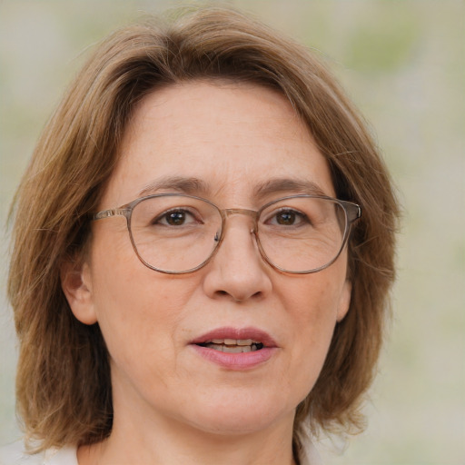 Joyful white middle-aged female with medium  brown hair and blue eyes