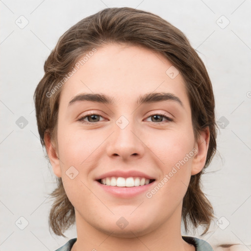 Joyful white young-adult female with medium  brown hair and grey eyes