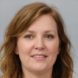 Joyful white adult female with long  brown hair and brown eyes