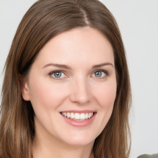 Joyful white young-adult female with long  brown hair and green eyes