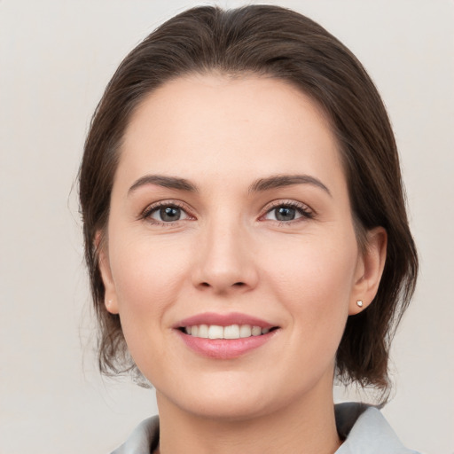 Joyful white young-adult female with medium  brown hair and brown eyes