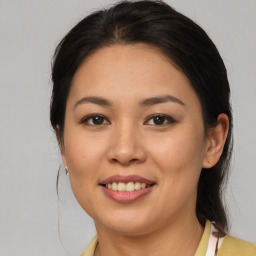 Joyful latino young-adult female with medium  brown hair and brown eyes