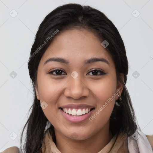 Joyful latino young-adult female with medium  brown hair and brown eyes