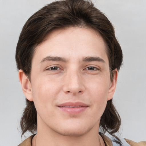 Joyful white young-adult male with medium  brown hair and brown eyes